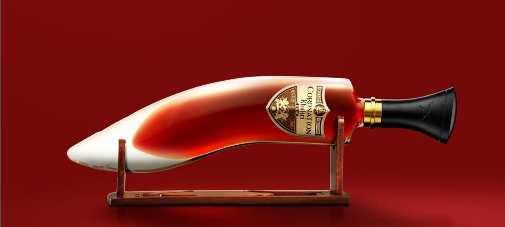 Khukri Coronation Rum in its iconic handcrafted bottle shaped like a traditional Nepali kukri dagger, presented in a premium gift box.
